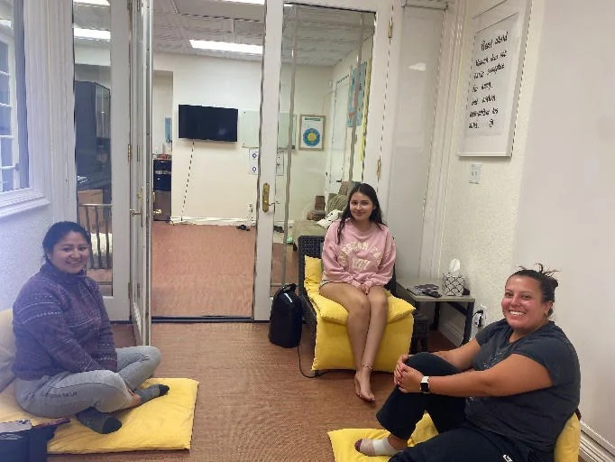 Two San Diego Meditation Center members sharing a warm hug
